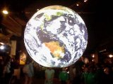 A cool projected holographic globe cycling through various planets