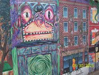A weird mural on a brick wall